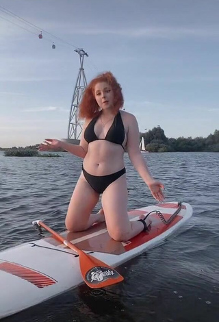 Beautiful Elizaveta Strizh Shows Cleavage in Sexy Black Bikini in the Sea