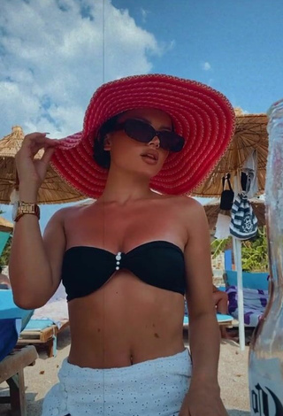 Hot Grisela Shows Cleavage in Black Bikini Top at the Beach