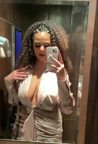 4. Sexy peachy.mely Shows Cleavage in Beige Dress