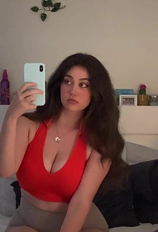 3. Attractive Simone Shows Cleavage in Red Crop Top