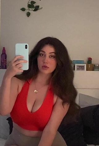 5. Attractive Simone Shows Cleavage in Red Crop Top