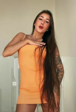 6. Sexy Julieta Shows Cleavage in Orange Dress