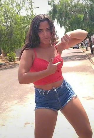 Attractive Raquel Toledoh Shows Cleavage in Red Crop Top