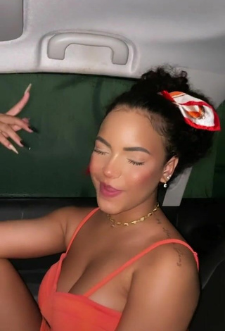 Sexy Ziane Martins Shows Cleavage in Orange Dress in a Car