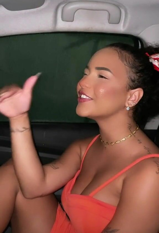 4. Sexy Ziane Martins Shows Cleavage in Orange Dress in a Car