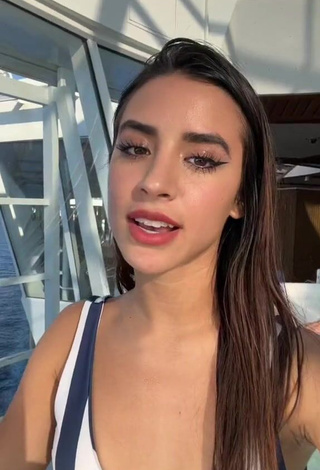 Dazzling Tammy Parra Shows Cleavage in Inviting Striped Bikini Top at the Swimming Pool