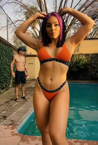 Seductive Karla Bustillos Shows Cleavage in Orange Bikini at the Swimming Pool