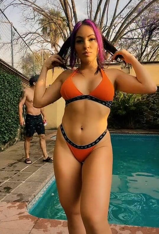 2. Seductive Karla Bustillos Shows Cleavage in Orange Bikini at the Swimming Pool