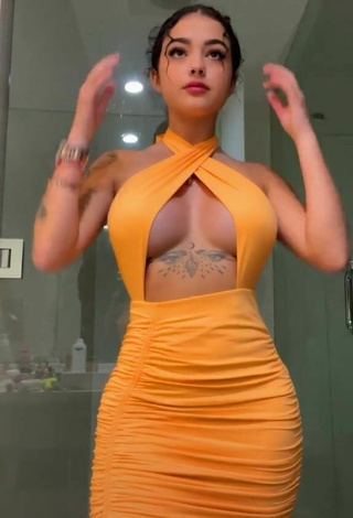 Cute Malu Trevejo Shows Cleavage in Orange Dress