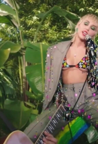Sexy Miley Cyrus Shows Cleavage in Bikini Top