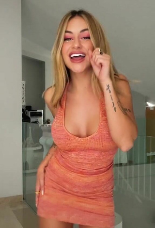 2. Sexy Abril Cols Shows Cleavage in Orange Dress